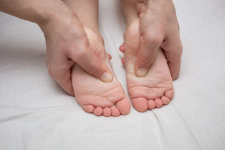The therapeutic massage for a baby's feet.の写真素材