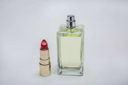 Cosmetic set on white background. Lipstick and eau de toilette.の写真素材