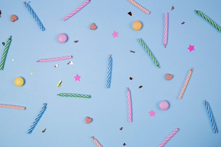 Candles for birthday party on blue background.の写真素材