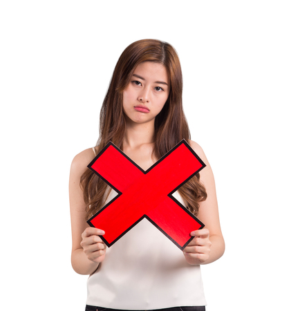 Asian woman holding wrong mark on isolated background.の写真素材