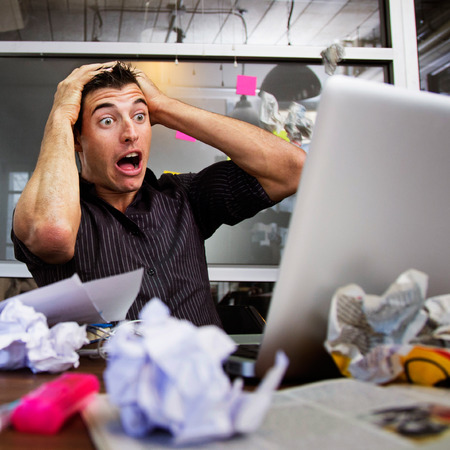 Strain businessman at desk in office