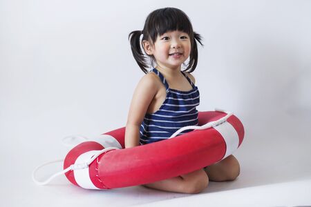 Cute and innocent japanese kid with life ring on white background