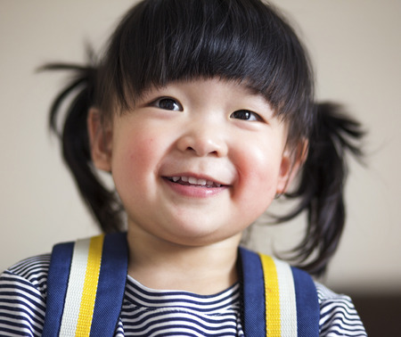 Lovely and innocent asian kid smiled happilyの写真素材