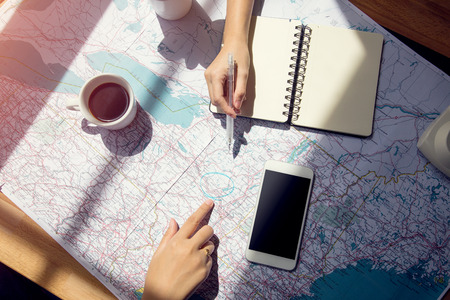 Planning on world map for traveling with accessories,notepad coffee cup and mobile phoneのeditorial素材