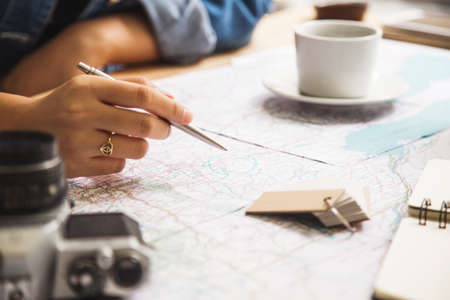Travel planning - map with notepad, pen and cameraのeditorial素材