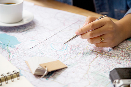 Point the place for traveling on map at officeの写真素材