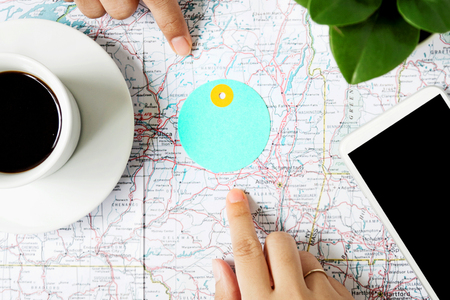 Pointing at map where traveling on world mapの写真素材