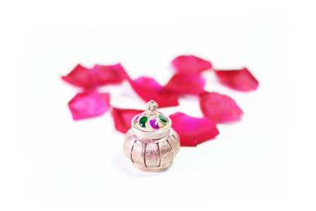 Lovely vermilion bowl red rose petals with white background close-up photo shootの写真素材