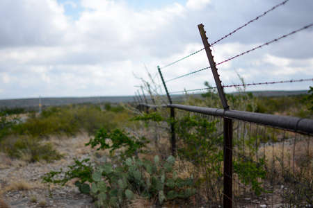 barbed wire steel wall against the in between India & Bangladeshの写真素材