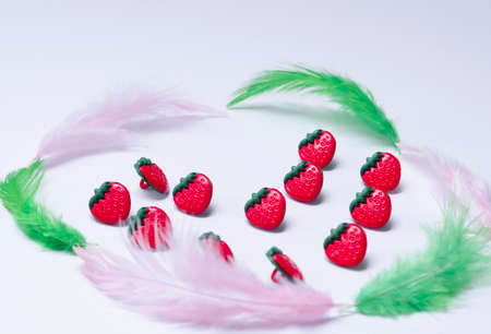 Conceptual strawberries with feather. flat lay romanticの写真素材