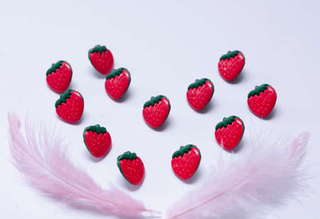 Conceptual strawberries with feather. flat lay romanticの写真素材