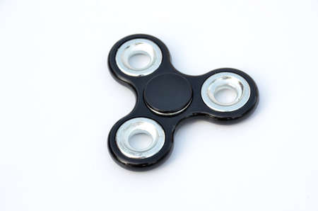 the black silver spinner isolated on white background.の写真素材