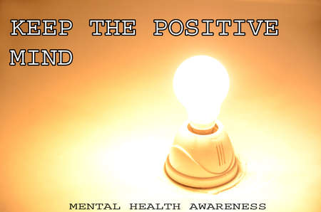 keep the positive mind with light bulb concept mental health awareness on the yellow white background.の写真素材