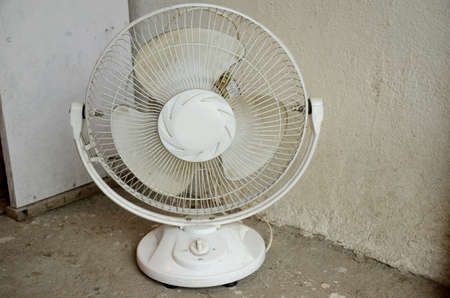 closeup the white color table fan keep in the floor on the white grey background.の写真素材