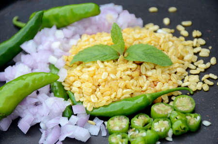 closeup the fried yellow gram split lentils with mint ,green chilly, sliced onion, over out of focus...