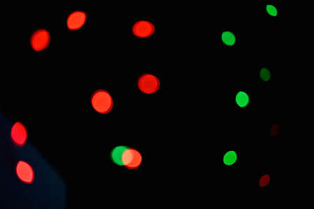 closeup the red green lighting bubbles over out of focus black background.