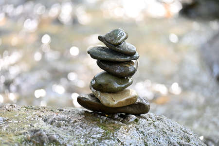 closeup the bunch brown stone in the row over out of focus grey brown background.の写真素材