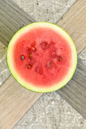 closeup the fresh sliced red ripe watermelon soft focus natural grey brown background.
