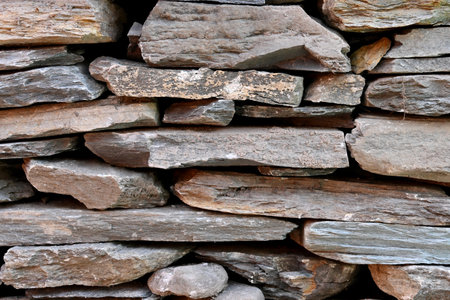 closeup the bunch grey brown stone wall soft focus natural grey brown background.の写真素材
