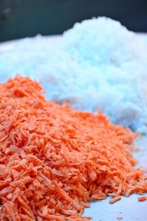 closeup the bunch ripe sliced white radish with orange carrots soft focus natural grey orange background.の写真素材