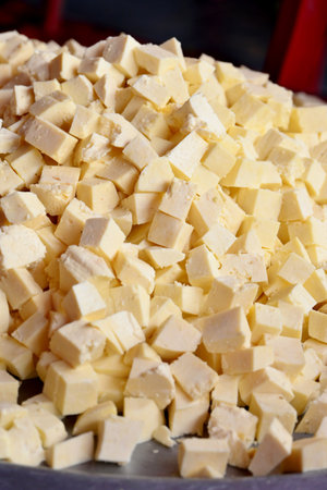 closeup the bunch yellow white sliced cheese soft focus yellow brown background.の写真素材