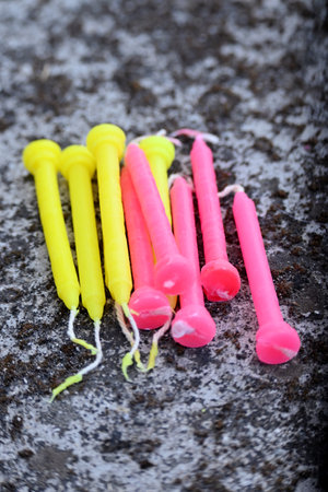 closeup the bunch colorful yellow pink candles in the the row soft focus natural grey brown background.の写真素材