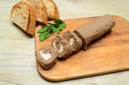 Roll pate, slices of toasted bread, wooden background.の写真素材