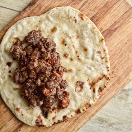 Mexican cuisine. Fried tortilla with meat. Cooking processes. Tonedの写真素材