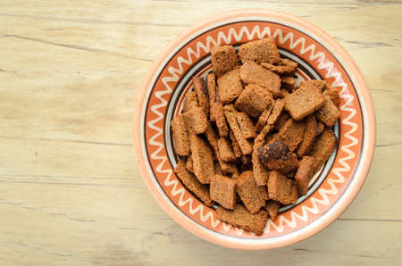 Rusks in a bowl on a wooden tableの写真素材