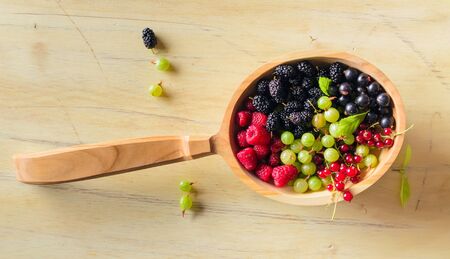 Berries on Wooden Background. Summer Organic Berry over Wood. Agriculture, Gardening, Harvest Conceptの写真素材