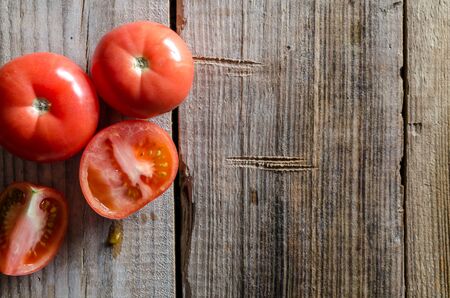top view of red tomatoes on wooden tableの写真素材