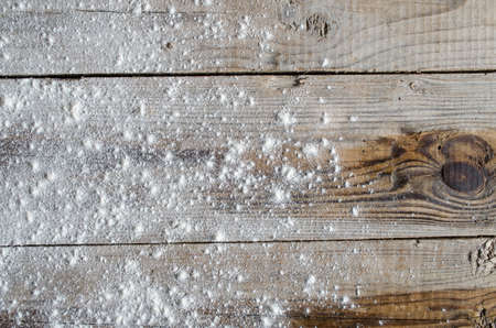 Rustic wooden background with dusting of flourの写真素材