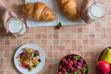 Croissants, raspberries and candied fruits on the table, healthy breakfast. View from above.の写真素材