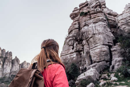 Young woman explorer with her backpack looking at the mountain. Concept of adventure, excursion and trips.の写真素材