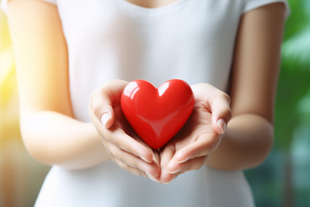 Woman holding red heart on blurred background, closeup. Charity concept Happy Women's Dayの素材