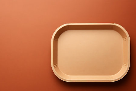 Empty plastic food container on brown background. Top view. Copy space.の素材