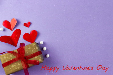 valentines day greeting card concept. Place for your text, blue gray background, wrapped gift and red hearts.の写真素材