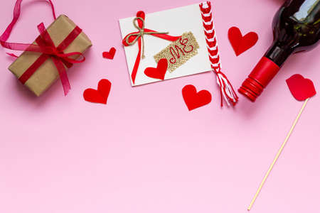 Valentine's day greeting card with coffee in white cup and valentine with love me lettering on pink background. Top view with a place to greet. Flat lay.の写真素材