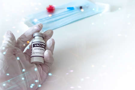 Vaccination concept. A vial with a vaccine in the doctor's hand for the prevention, immunization and...