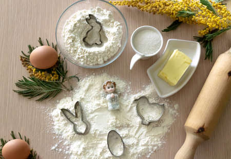 Step-by-step instructions for making Easter cookies. Ingredients for baking on a wooden light...