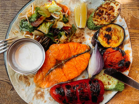 Flat lay menu grilled red fish and vegetables close-up.