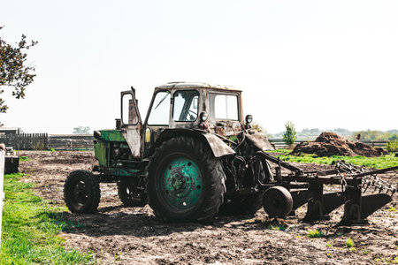 Agricultural seasonal work, a tractor plows the land for sowing seedlings, horizontal photo on a...