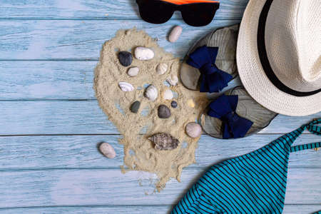 Concept of the summer time, travel. Beach accessories on a light blue wooden background with place for your text. Flat lay.の写真素材