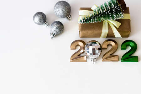 Top view of happy new year background with copy space, numbers 2022 and craft gifts on light...