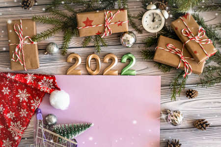 Flat lay happy new year greeting card with copy space very peri color, craft gifts, numbers 2022 for and other on light wooden background.の写真素材