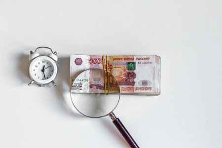 Saving money savings concept, Russian five thousand rubles banknotes under a magnifying glass, financial management time.の写真素材