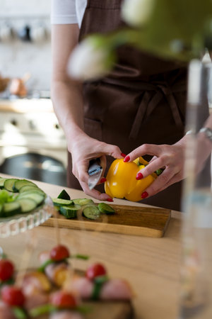 Cooking in the kitchen diet menu, healthy food, takeaway ready snacks. Hands of the chef in the frame cutting vegetables.の写真素材
