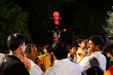 Jaipur, India - 13th oct 2013  Indian family enjoying the dussera carnival  The effigy of Ravan is visible in the background  This is burnt to smbolize the victory of good over evilのeditorial素材
