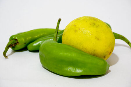 lemon and chillies against a white background  Indian superstition says that this combination wards off evil influences and is auspicious の写真素材