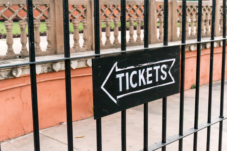 Ticket signboard on a metal fenceの写真素材